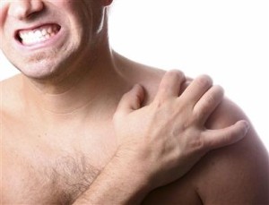 man clutching shoulder in pain